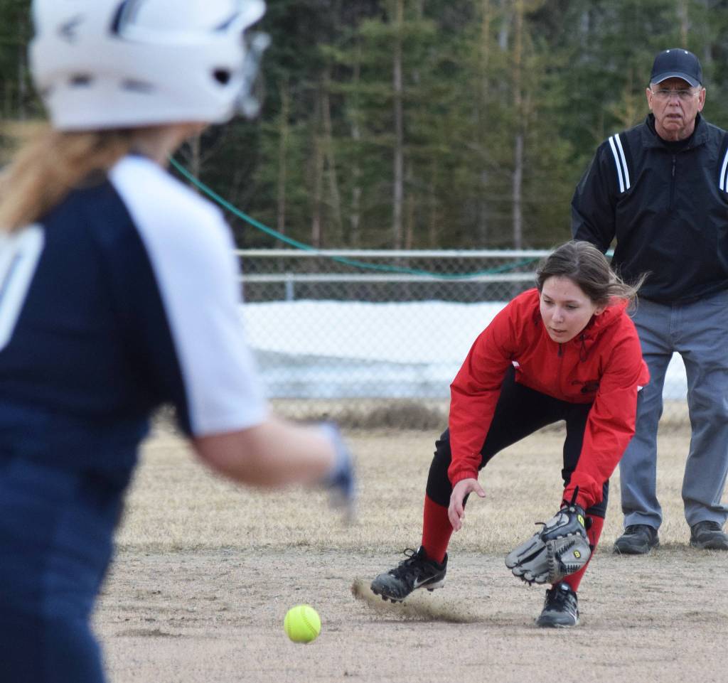 Kenai Centrals Leinani Rapoza fields a ground ball from Soldotnas Lillian Gomez Thursday, April 25, 2019, at the Soldotna Softball Fields. (Photo by Joey Klecka/Peninsula Clarion)