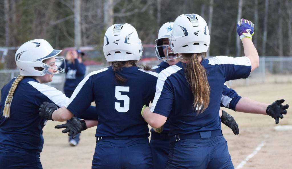Soldotnas Bailey Berger (second from right) receives congratulations from teammates after hitting a home run Thursday, April 25, 2019, against Kenai Central at the Soldotna Softball Fields. (Photo by Joey Klecka/Peninsula Clarion)