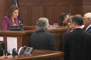 Senate President Cathy Giessel, left, listens to Senate leaders on the floor at the Alaska State Capitol on Wednesday, May 1, 2019. (Alex McCarthy | Juneau Empire)