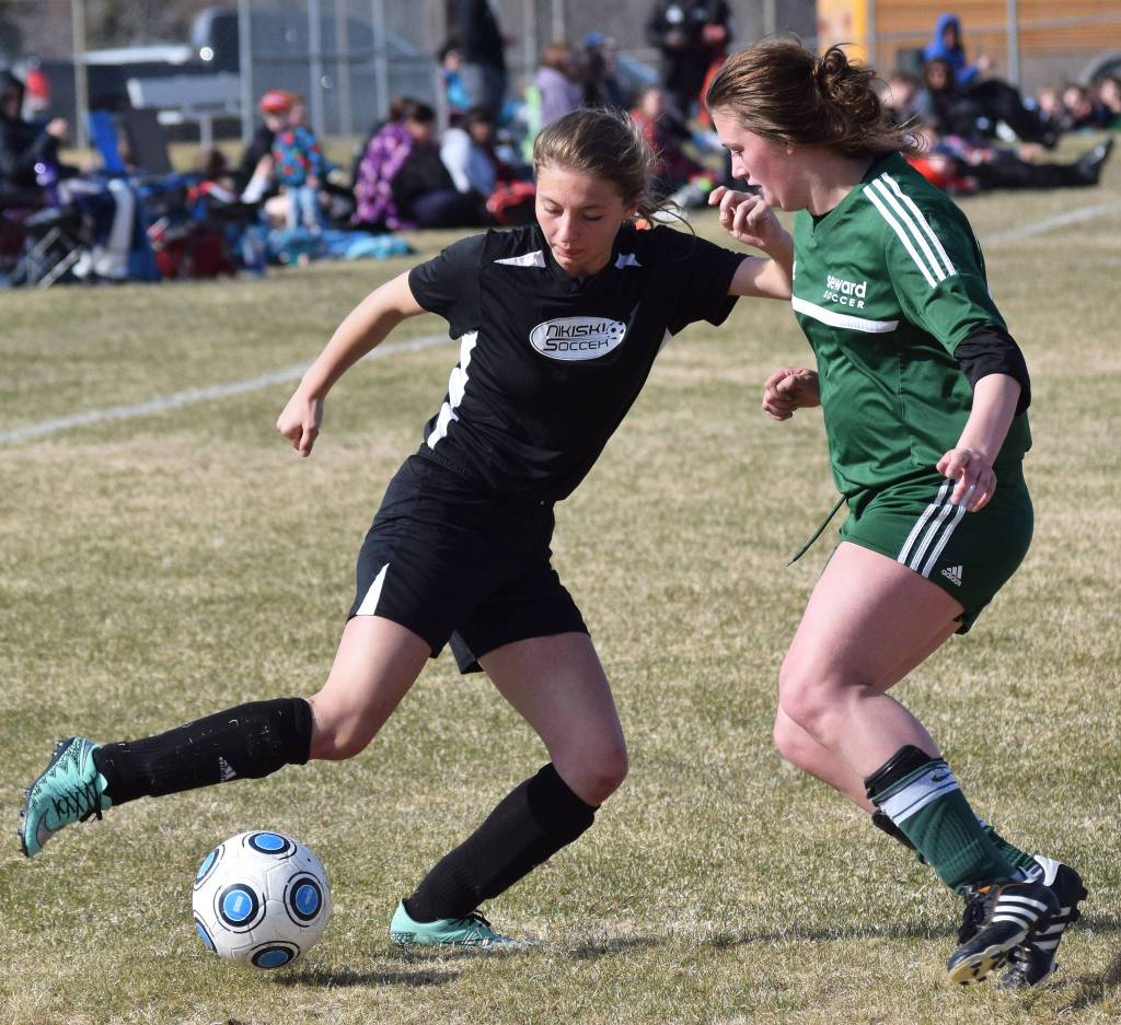 Nikiskis America Jeffreys (left) works to find a way around Seward defender Shelly Sewell Friday afternoon in a Peninsula Conference contest at Nikiski High School. (Photo by Joey Klecka/Peninsula Clarion)