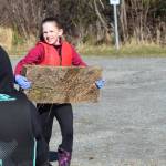 A Redoubt Elementary student carries a piece of wood to the trash pile during the 6th Annual Kids Kenai River Spring Cleanup at Swiftwater Park in Soldotna, Alaska on May 3, 2019. (Photo by Brian Mazurek/Peninsula Clarion)