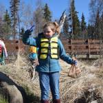 A student from Redoubt Elementary holds up a discarded fishing line and lure during the 6th Annual Kids Kenai River Spring Cleanup at Swiftwater Park in Soldotna, Alaska on May 3, 2019. (Photo by Brian Mazurek/Peninsula Clarion)