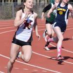 Kenais Hayley Maw rounds a turn ahead of Homers Laura Inama in the girls 200 meter final Saturday, May 4, 2019, at the Kenai Invitational track meet at Kenai Central High School. (Photo by Joey Klecka/Peninsula Clarion)