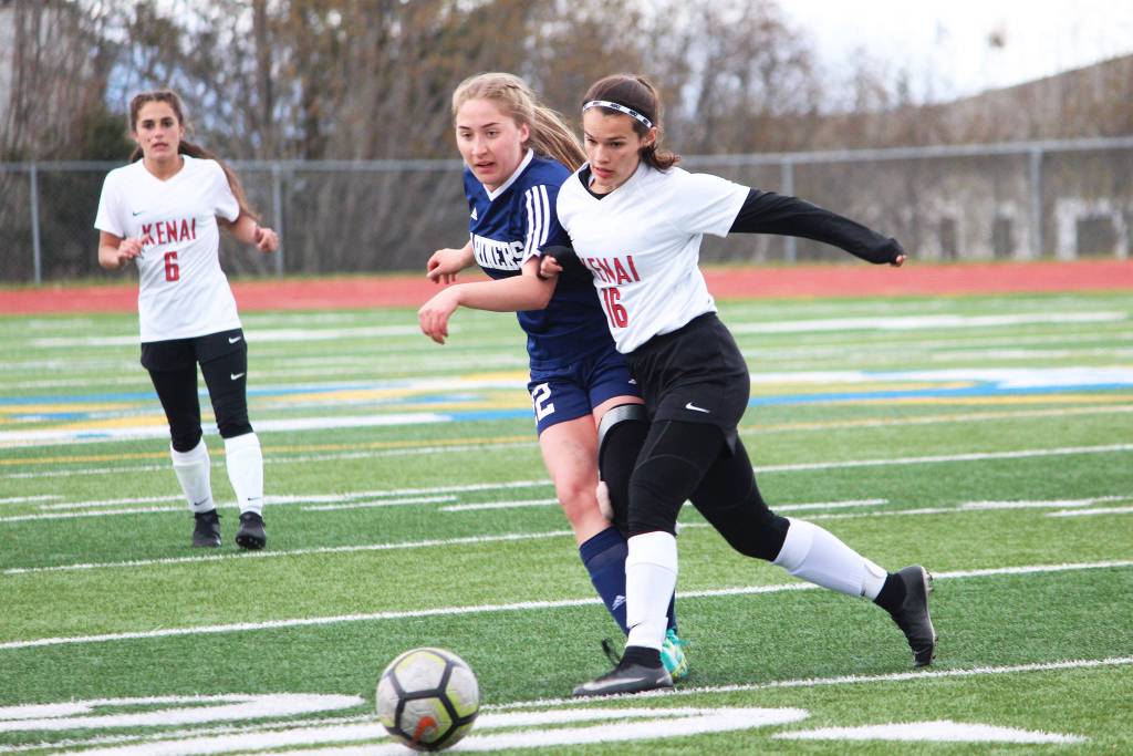 Homers Brenna McCarron makes a pass under pressure from Kenais Taylor Pierce during a Thursday, May 9, 2019 soccer game at Homer High School in Homer, Alaska. (Photo by Megan Pacer/Homer News)