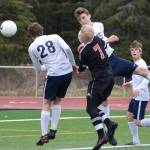 Kenais Leif Lofquist (7) gets sandwiched between Homers Phinny Weston (28) and Ethan Pitzman Thursday, May 9, 2019, in Kenai, Alaska. (Photo by Joey Klecka/Peninsula Clarion)