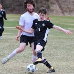 Nikiskis Isaiah Gray (13) battles for the ball with a Houston defender Friday, May 10, 2019, in a nonconference game in Nikiski, Alaska. (Photo by Joey Klecka/Peninsula Clarion)