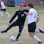 Nikiskis Jace Kornstad (20) makes a play on the ball in front of Houstons Owen Mulhaney Friday, May 10, 2019, in a nonconference game in Nikiski, Alaska. (Photo by Joey Klecka/Peninsula Clarion)