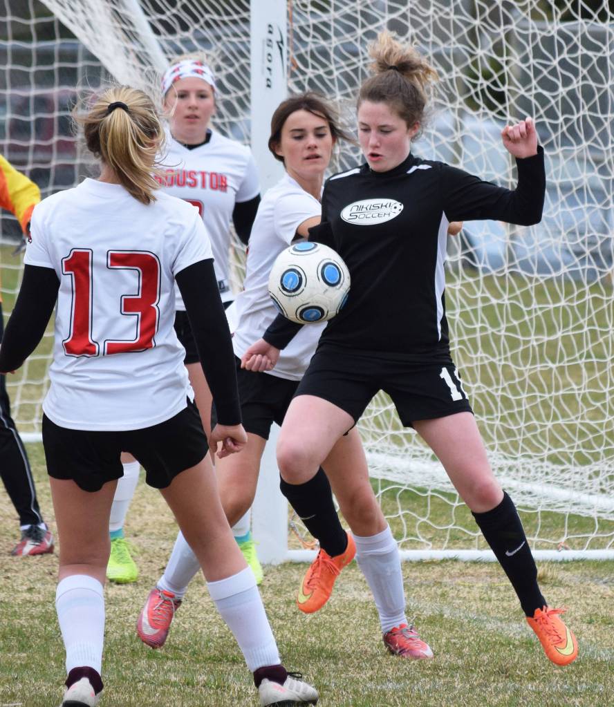Nikiskis Jordyn Stock (right) attempts to corral the ball in front of the Houston goal Friday, May 10, 2019, in a nonconference game in Nikiski, Alaska. (Photo by Joey Klecka/Peninsula Clarion)