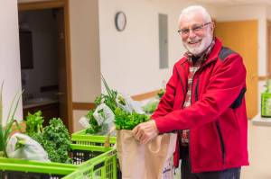 Alaska Food Hub customer Roger Clyne picks up his order at one of the Food Hubs designated locations in this undated photo. (Photo courtesy of Robbi Mixon/Alaska Food Hub)