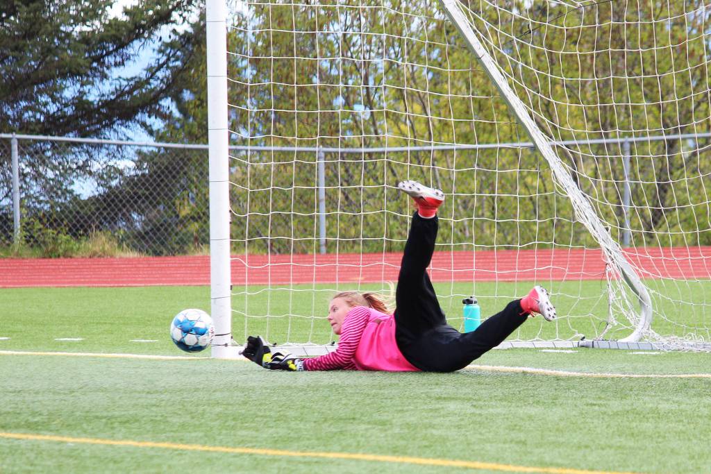 Kenai goalkeeper Kailey Hamilton dives for a ball on a penalty kick during the semi-final game of the Peninsula Conference Soccer Tournament on Friday, May 17, 2019 at Homer High School in Homer, Alaska. The game went into penalty kicks when the score remained tied after a regulation game and two halves of overtime. (Photo by Megan Pacer/Homer News)