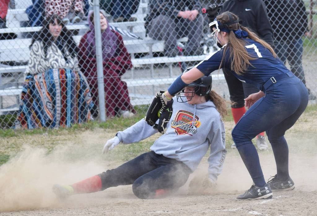 Kenais Abby Every slides home in front of the tag of Soldotna pitcher Casey Earll Friday, May 17, 2019, at Steve Shearer Memorial Ballpark in Kenai, Alaska. (Photo by Joey Klecka/Peninsula Clarion)