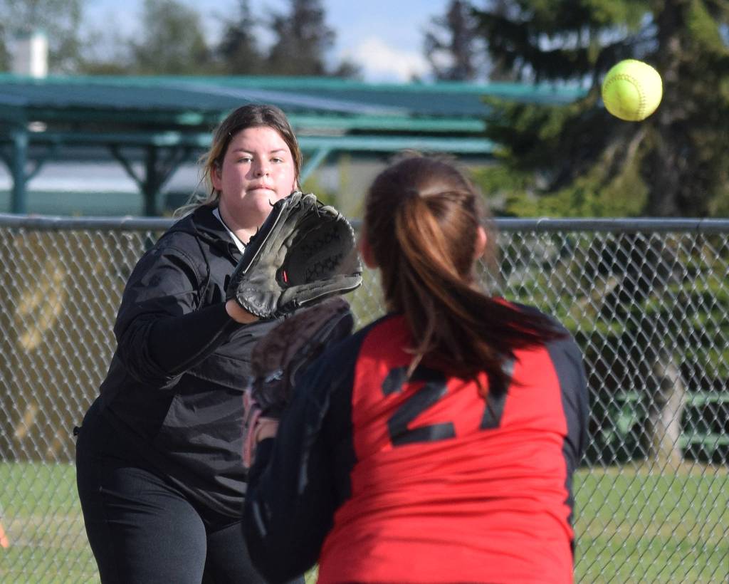 Kenai first baseman Taylor Garver catches a ball from teammate Kaylee Lauritsen for an out against Soldotna Friday, May 17, 2019, at Steve Shearer Memorial Ballpark in Kenai, Alaska. (Photo by Joey Klecka/Peninsula Clarion)