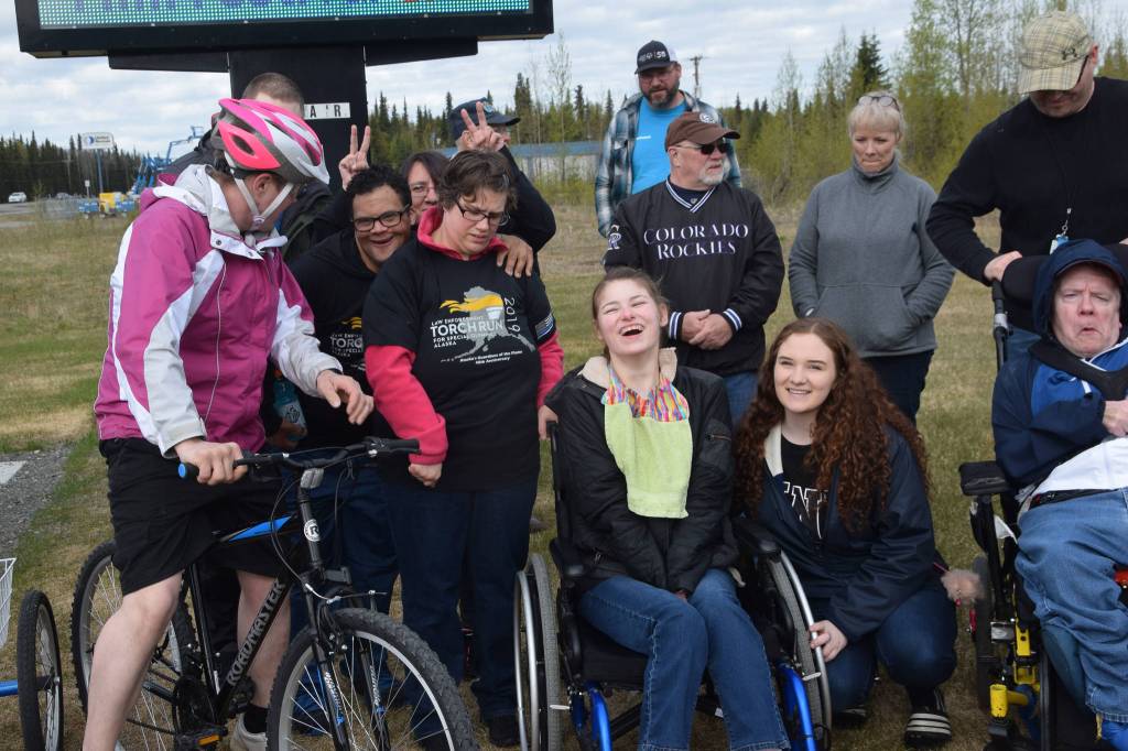 Participants in the annual Special Olympics Torch Run smile for a photo outside the Soldotna Regional Sports Complex in Soldotna Alaska on May 18, 2019. (Photo by Brian Mazurek/Peninsula Clarion)