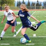 Homers Brenna McCarron (right) prepares to send the ball up the field under pressure from Soldotnas Ryann Cannava during the girls championship game of the Peninsula Conference soccer tournament on Saturday at Homer High School in Homer. (Photo by Megan Pacer/Homer News)