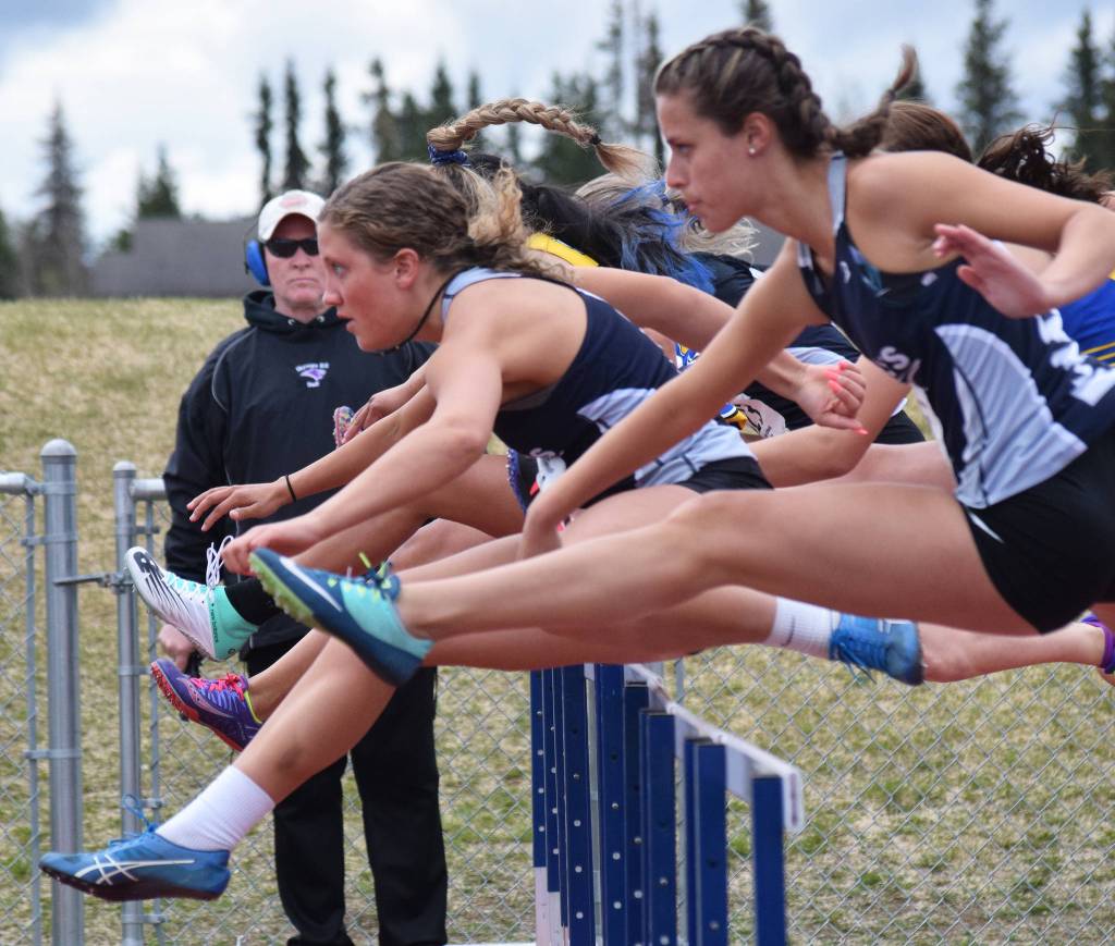 Soldotnas Kylie Ness (left) and teammate Sophie Thomas lead the pack over the first hurdle in the Class 3A girls 100-meter hurdles Saturday, May 18, 2019, at the Region III Track and Field Championships in Soldotna, Alaska. (Photo by Joey Klecka/Peninsula Clarion)