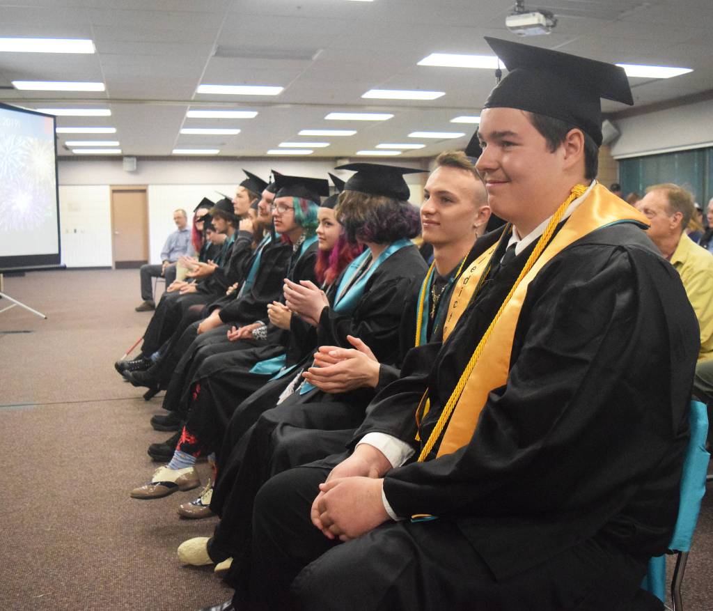 River City Academy valedictorian Steven Hunter Smith (front) awaits the presentation of diplomas Tuesday, May 21, 2019, at the Soldotna Regional Sports Complex in Soldotna, Alaska. (Photo by Joey Klecka/Peninsula Clarion)