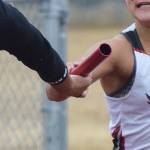 Kenai sophomore Alyssa Bucho (right) hands the baton off to senior teammate Tekaiya Rich in the girls 400-meter sprint relay April 27, 2019, at the Kenai Invitational at Ed Hollier Field. (Photo by Joey Klecka/Peninsula Clarion)