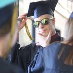 Isabella Koch helps Garrett Koch perfect the finishing touches before they walk in their graduation ceremony Tuesday, May 21, 2019 at Ninilchik School in Ninilchik, Alaska. They are two of four total Ninilchik graduates this year. (Photo by Megan Pacer/Homer News)