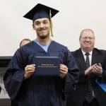 Ninilchik School graduate Jacob Shell receives his diploma during a Tuesday, May 21, 2019 graduation ceremony at the school in Ninilchik, Alaska. (Photo by Megan Pacer/Homer News)