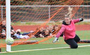 Kenai Central goalkeeper Kailey Hamilton wards off a penalty kick shot from North Pole late in a game Thursday, May 23, 2019, at the Div. II state soccer championships in Eagle River. (Photo by Joey Klecka/Peninsula Clarion)