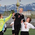 Kenais Leif Lofquist gets his head on a ball against Grace Christian Thursday, May 23, 2019, at the Div. II state soccer championships at West High School. (Photo by Joey Klecka/Peninsula Clarion)