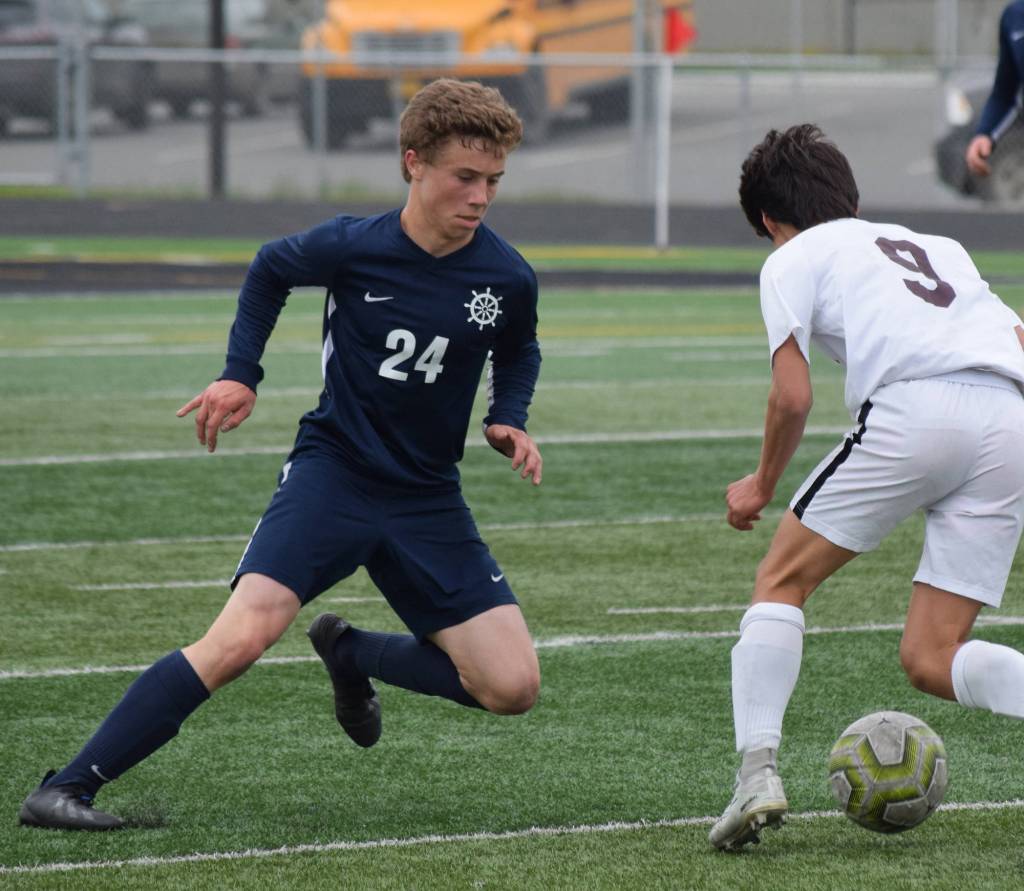 Homers Austin Shafford (left) defends a move by Ketchikans Apollo Jasper Thursday, May 23, 2019, at the Div. II state soccer championships at West High School. (Photo by Joey Klecka/Peninsula Clarion)