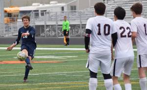 Homers Phinny Weston delivers a free kick against a line of Ketchikan defenders Thursday, May 23, 2019, at the Div. II state soccer championships at West High School. (Photo by Joey Klecka/Peninsula Clarion)