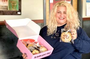 Molly Blakeley holds up one of her maple bacon cookies that comes in her Molly BS Bingerz cookie subscription boxes, Thursday, May 16, 2019, in Soldotna, Alaska. (Photo by Victoria Petersen/Peninsula Clarion)