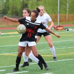 Juneaus Malia Miller grounds the ball under pressure from Kenai Central players in a Friday, May 24, 2019 semifinal game during the Division II state soccer championships at Service High School in Anchorage, Alaska. (Photo by Megan Pacer/Homer News)