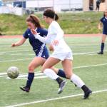 Soldotnas Katherine Bramante and Thunder Mountains Keana Villanueva race to the ball during a semifinal game at the Division II state soccer championships Friday at Service High School in Anchorage. (Photo by Megan Pacer/Homer News)