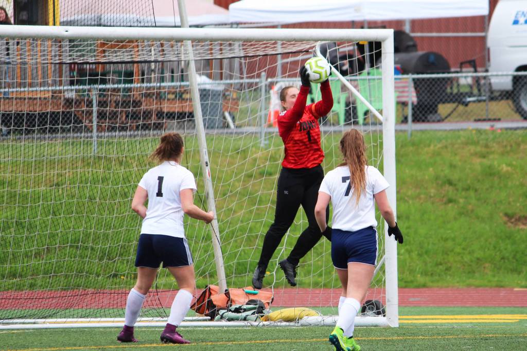 Juneau goalkeeper Shaylin Cesar grabs a ball out of the air on a shot from Soldotnas team during the final game of the Division II state soccer championships Saturday, May 25, 2019 at Service High School in Anchorage, Alaska. (Photo by Megan Pacer/Homer News)