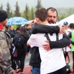 Kenai boys soccer team head coach Shane Lopez hugs player Travis Verkuilen as they celebrate their win over Juneau in the Saturday final game of the Division II state soccer championships at Service High School in Anchorage. (Photo by Megan Pacer/Homer News)