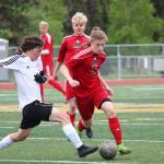 Kenais Damien Redder (left) fights for the ball with Juneaus Jackson Norberg during the championship game of the Division II state soccer tournament Saturday at Service High School in Anchorage. (Photo by Megan Pacer/Homer News)
