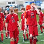 Members of the Juneau Douglas boys soccer team walk off the field in tears after a 3-2 loss to Kenai in the championship game of the Division II state soccer tournament Saturday. May 25, 2019 at Service High School in Anchorage, Alaska. The game went into three halves of overtime before it was over. (Photo by Megan Pacer/Homer News)