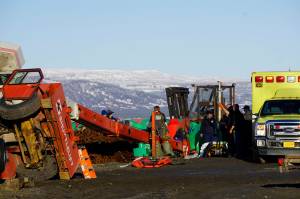Homer Volunteer Fire Department emergency medical technicians treat Chief Warrant Officer Michael Kozloski, a crew member of the U.S. Coast Guard Cutter Hickory, after he was injured when a crane tipped over at the Pioneer Dock on the Homer Spit on Thursday, Jan. 31, 2019, in Homer, Alaska. Kozloski was later pronounced dead at South Peninsula Hospital. (Photo by Michael Armstrong/Homer News.)