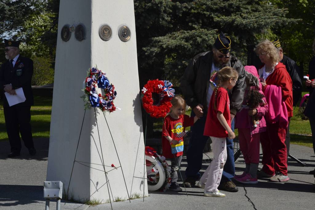 Families were invited to place flowers and wreaths in remembrance of fallen service members at Kenais Memorial Day ceremony on Monday, May 27, 2019, at Leif Hansen Memorial Park in Kenai, Alaska. (Photo by Victoria Petersen/Peninsula Clarion)                                Families were invited to place flowers and wreaths in remembrance of fallen service members at Kenais Memorial Day ceremony on Monday, May 27, 2019, at Leif Hansen Memorial Park in Kenai, Alaska. (Photo by Victoria Petersen/Peninsula Clarion)