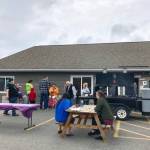 Residents eat brats and hot dogs during the Kenai Peninsula Food Bank Spring Festival and Fundraisers free community picnic, an event meant to thank the community, Friday, May 31, 2019, near Soldotna, Alaska. (Photo by Victoria Petersen/Peninsula Clarion)