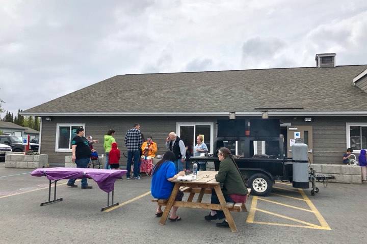 Residents eat brats and hot dogs during the Kenai Peninsula Food Bank Spring Festival and Fundraisers free community picnic, an event meant to thank the community, Friday, May 31, 2019, near Soldotna, Alaska. (Photo by Victoria Petersen/Peninsula Clarion)
