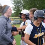 Homers Annalynn Brown (center) is mobbed by teammates after hitting a home run against Delta Junction at the Division II state softball tournament Friday, May 31, 2019, at Cartee Fields in Anchorage, Alaska.