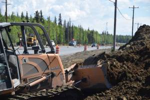 Construction crews excavate along the side of the Kenai Spur Highway in Soldotna, Alaska, on Tuesday, June 4, 2019. (Photo by Brian Mazurek/Peninsula Clarion)