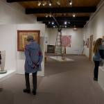 Visitors view the All Alaska Biennial exhibit at the Pratt Museum for its grand reopening on May 25, 2019, in Homer, Alaska. The Special Exhibits Gallery staircase at back was redone to expand the gallery space and add a three-stop lift. (Photo by Michael Armstrong/Homer News)
