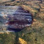 A photo of the Tustumena Lake Fire taken at 11 p.m. on Wednesday illustrates the effect retardant and water drops had on the fire. (Photo by Jason Jordet/Alaska Division of Forestry)