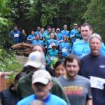 The field of 5K runners stream through the woods Saturday, June 8, 2019, at the Run for the River 5-kilometer/10-mile races in Soldotna, Alaska. (Photo by Joey Klecka/Peninsula Clarion)