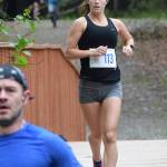 Womens 5K winner Riley Burroughs races over a bridge early Saturday, June 8, 2019, at the Run for the River 5-kilometer/10-mile races in Soldotna, Alaska. (Photo by Joey Klecka/Peninsula Clarion)