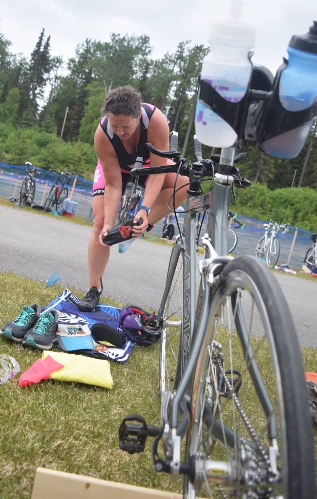 Eventual intermediate womens winner Katra Wedeking of Girdwood changes into shoes in the transition area Sunday, June 9, 2019, in the Tri-The-Kenai Triathlon in Soldotna, Alaska. (Photo by Joey Klecka/Peninsula Clarion)