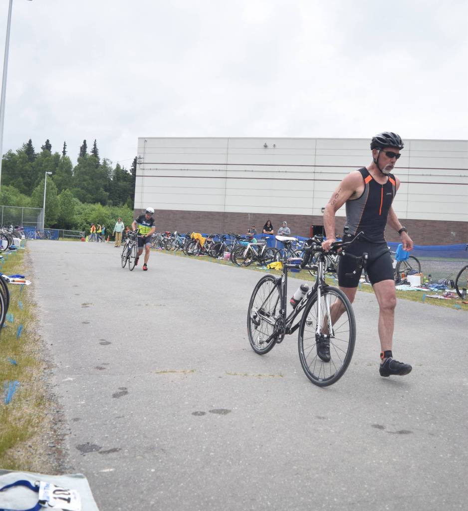 Anchor Points Kevin Chambers rolls out of the exchange zone Sunday, June 9, 2019, in the Tri-The-Kenai Triathlon in Soldotna, Alaska. (Photo by Joey Klecka/Peninsula Clarion)