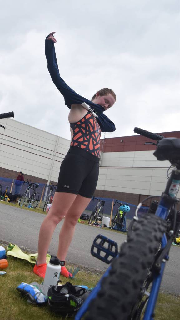 Anchorages Afton Milliman changes clothes as she prepares for the cycling leg Sunday, June 9, 2019, in the Tri-The-Kenai Triathlon in Soldotna, Alaska. (Photo by Joey Klecka/Peninsula Clarion)