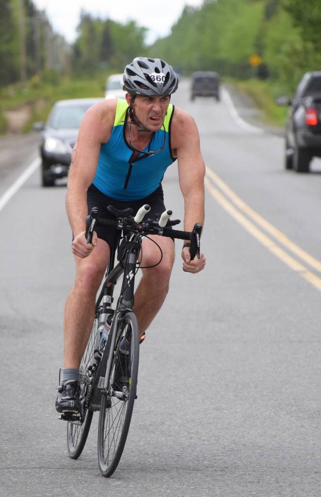 Homers Dan Miotke rides down Gas Well Road Sunday, June 9, 2019, in the Tri-The-Kenai Triathlon in Soldotna, Alaska. (Photo by Joey Klecka/Peninsula Clarion)