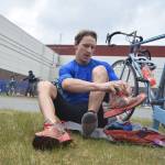 Mens sprint winner Tyler Osland changes into running shoes in the transition area Sunday, June 9, 2019, in the Tri-The-Kenai Triathlon in Soldotna, Alaska. (Photo by Joey Klecka/Peninsula Clarion)