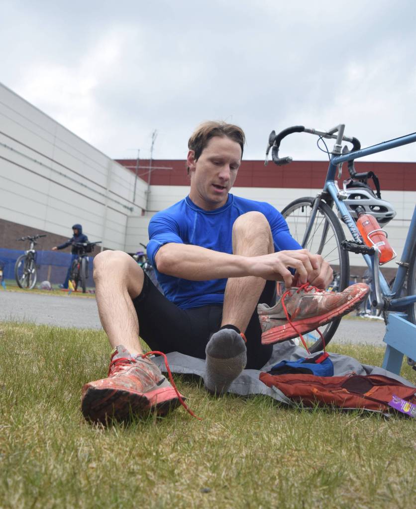Mens sprint winner Tyler Osland changes into running shoes in the transition area Sunday, June 9, 2019, in the Tri-The-Kenai Triathlon in Soldotna, Alaska. (Photo by Joey Klecka/Peninsula Clarion)